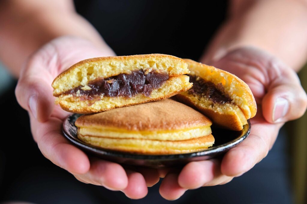Person offering japanese dorayaki.